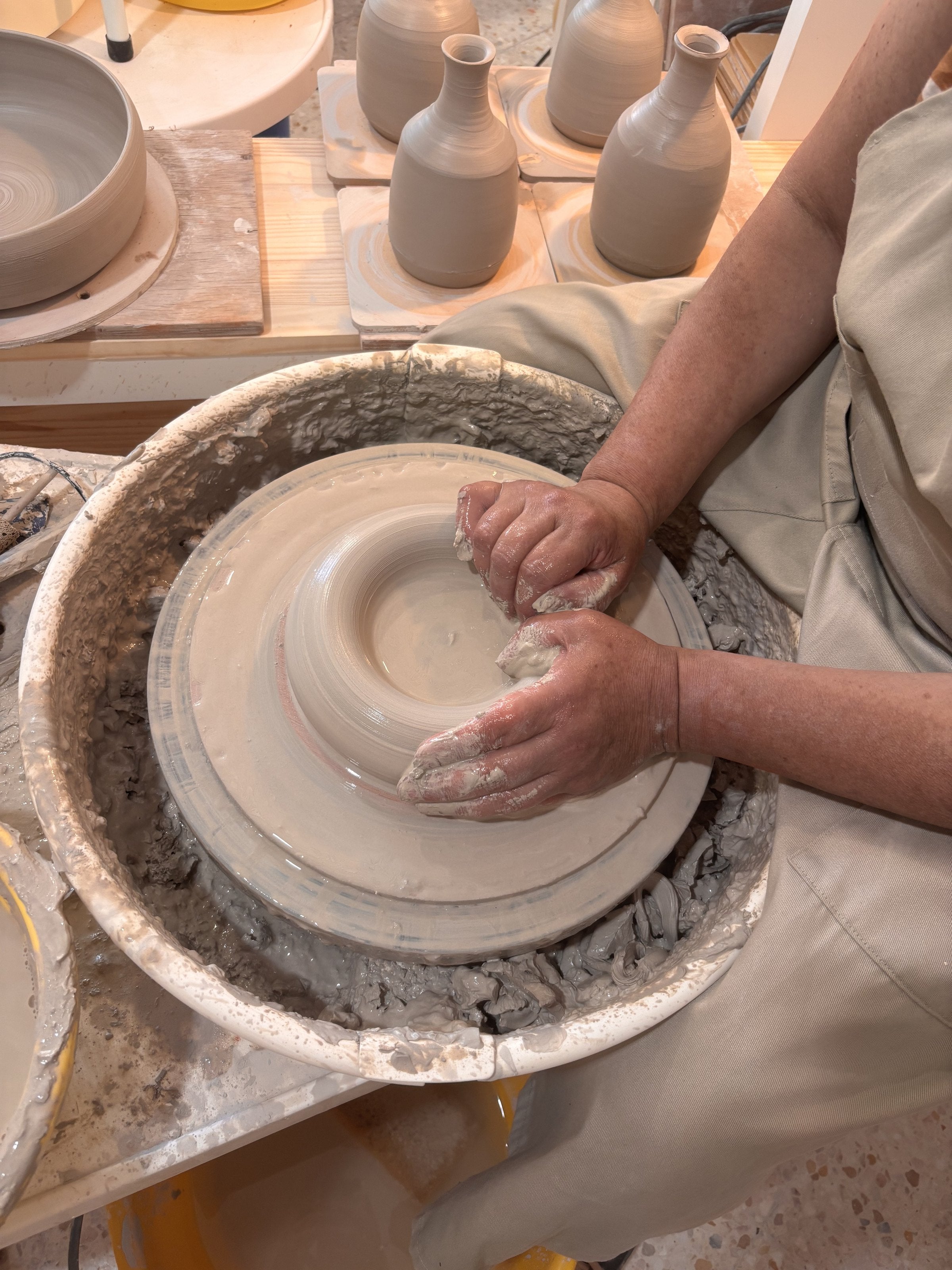Mains façonnant un bol sur le tour à l'Atelier Anne-Va